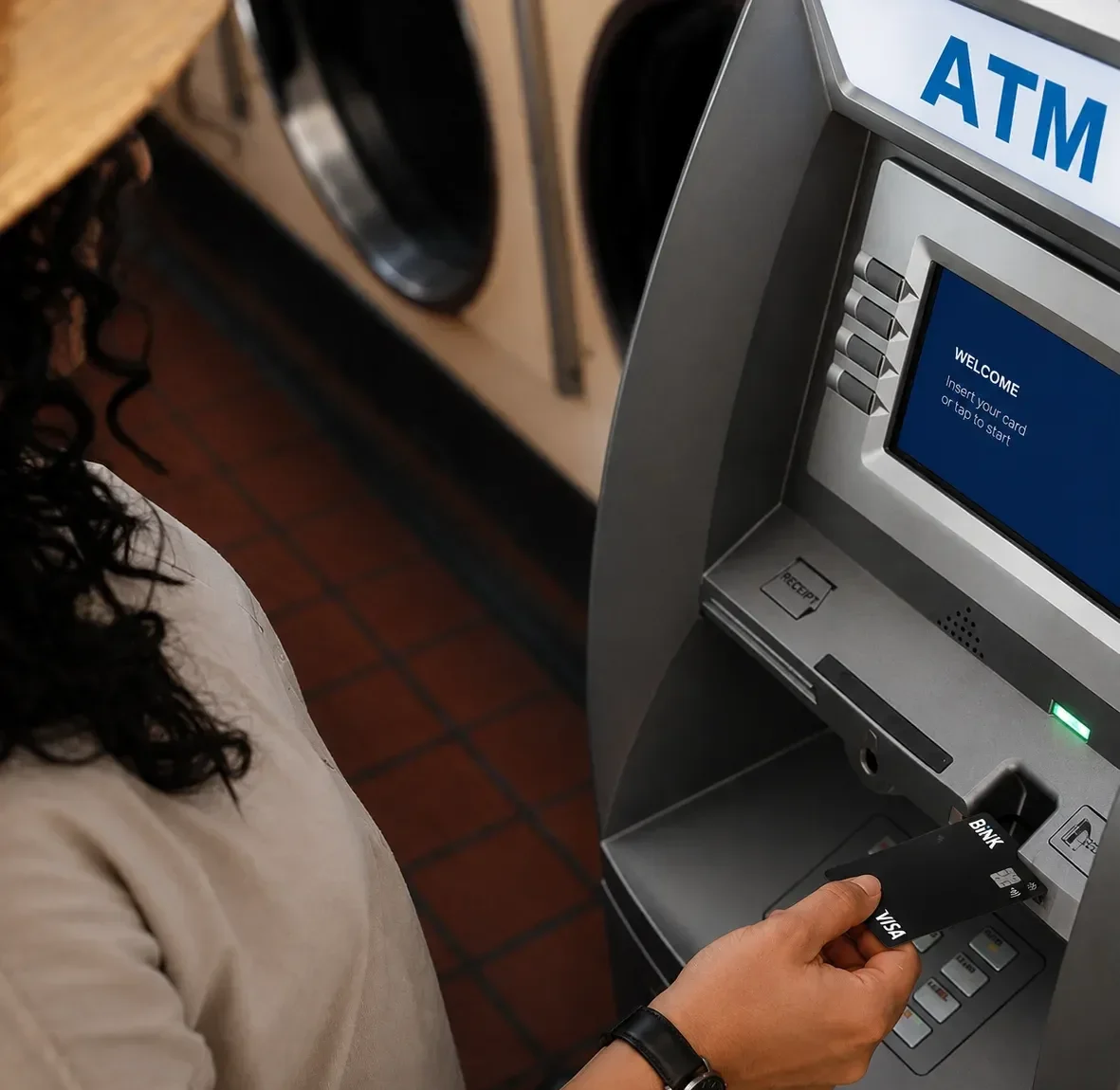 Someone inserting a BINK card into an ATM